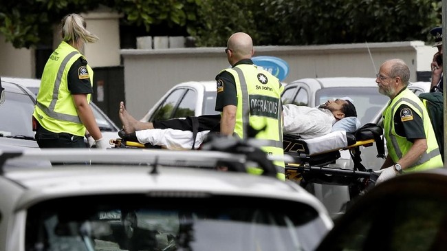 Ambulance staff take a man from outside a mosque in central Christchurch, New Zealand, Friday, March 15, 2019. A witness says many people have been killed in a mass shooting at a mosque in the New Zealand city of Christchurch.(AP Photo/Mark Baker)