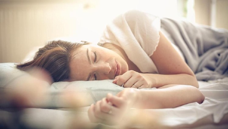 Young woman sleeping in bed. Space for copy.