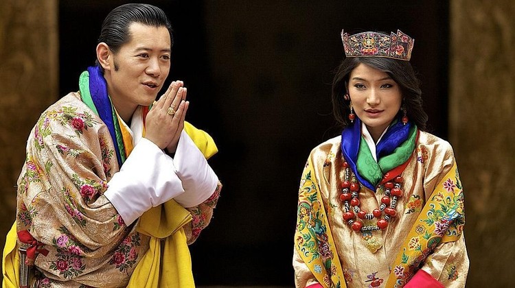 PARO, BHUTAN - OCTOBER 13:  His majesty King Jigme Khesar Namgyel Wangchuck (L), 31  with Queen Ashi Jetsun Pema (R), 21 greeting the media after the wedding ceremony on October 13, 2011 in Punakha, Bhutan. King Jigme Khesar Namgyel Wangchuck and Queen of Bhutan Ashi Jetsun Pema Wangchuck wed in Bhutan's historic 17th century Punakha Dzong  the same venue that hosted the King's historical coronation ceremony in 2008. The marriage of popular, Oxford-educated king was celebrated throughout the country's capital and countryside for several days.  (Photo by Triston Yeo/Getty Images)