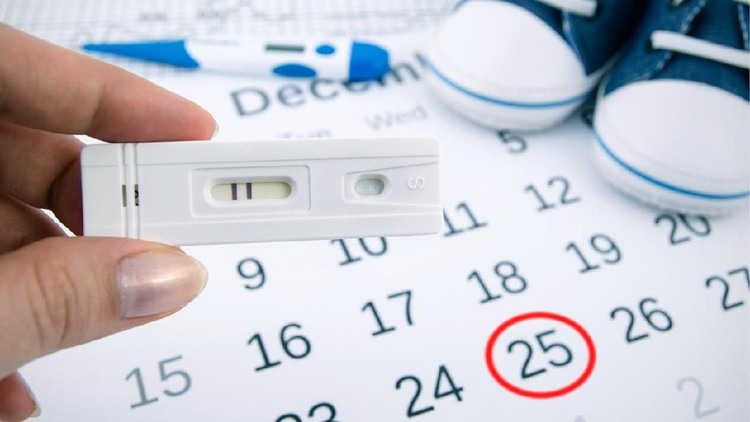 Positive pregnancy test on calendar with date of birth