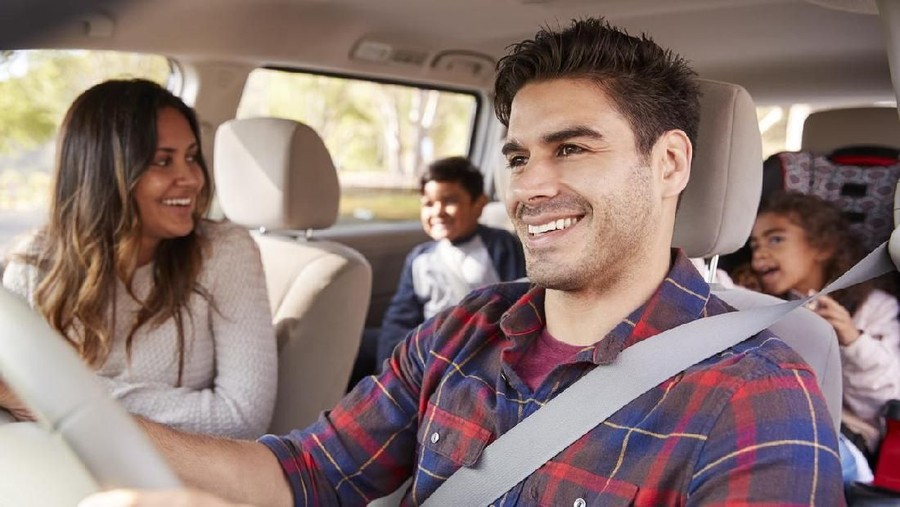 Mother turns around to her children on the back seat of car