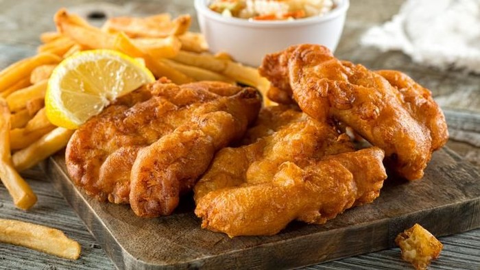 Frying wiener schnitzel in a hot pan with cooking oil