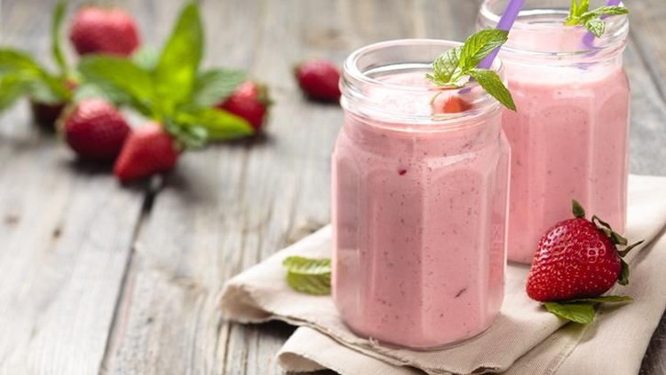 Fruit smoothie with mint leaves on wooden rustik table