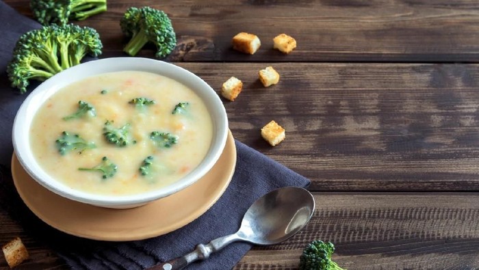 Vegetable and cheese cream soup with broccoli and croutons over wooden background with copy space - homemade healthy organic vegetarian vegan diet fresh food meal dish soup lunch