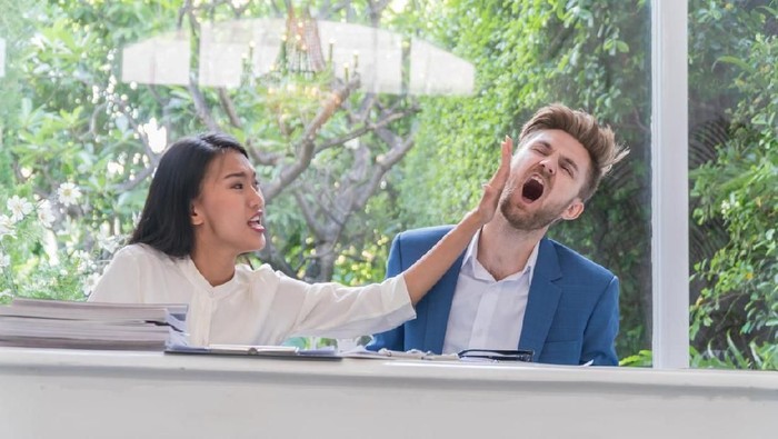 Boyfriend being slapped by his girlfriend because of infidelity.