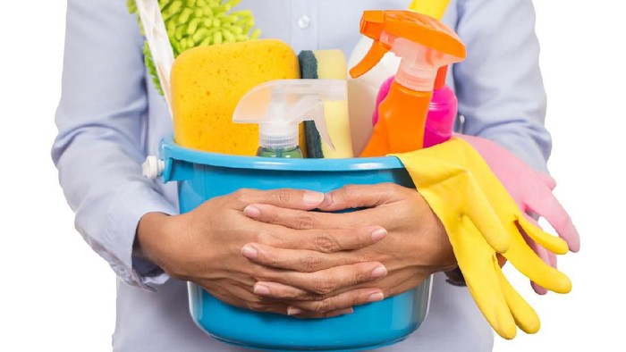 woman with cleaning equipment ready to clean house