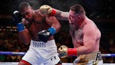 FOTO: Kejutan Andy Ruiz Menang TKO Atas Anthony Joshua Petinju asal Meksiko Andy Ruiz Jr. secara mengejutkan menjadi juara dunia kelas berat setelah menang TKO atas Anthony Joshua.