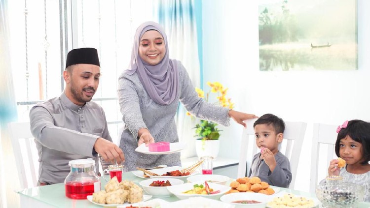 A Malay Muslim family having Hari Raya Aidlfitri/ Eid-Ul-Fitr meals at their home on in Malaysia.