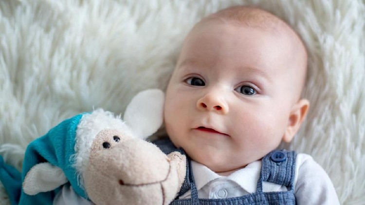 nama bayi Little cute baby boy, playing with toys at home, smiling at camera, wintertime