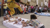 FOTO: Melompati Bayi Demi Mengusir Iblis di Spanyol Masyarakat Katolik di Sasamon, Spanyol punya cara sendiri untuk mengusir iblis atau roh jahat pada bayi mereka, dengan cara melompatinya dalam acara El Colacho.