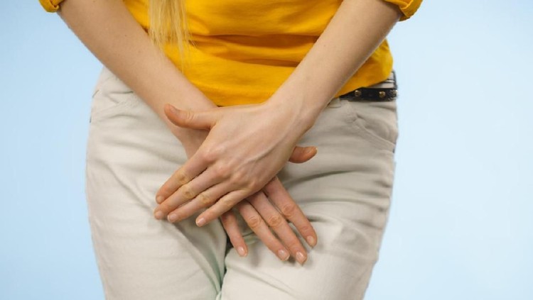 Closeup young sick woman with hands holding pressing her crotch lower abdomen. Medical or gynecological problems, healthcare concept