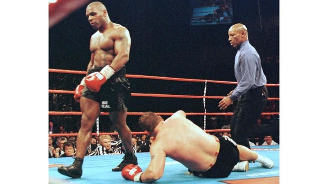 Mike Tyson (L) of the US walks away after knocking down Francois Botha (C) of South Africa as referee Richard Steele (R) walks in during the fifth round of their heavyweight fight 16 January at the MGM Grand Garden in Las Vegas, NV. Tyson won the fight by knockdown in the fifth round in their 10-round bout. It was Tyson's first fight since 28 June 1997 when he was disqualified for biting Evander Holyfield's ears during a world championship rematch. Fined three million dollars and banned from the ring after the incident, Tyson had his boxing license reinstated by the state Athletic Commission on 19 October 1998 after two hearings.   AFP PHOTO/Jeff HAYNES (Photo by JEFF HAYNES / AFP)