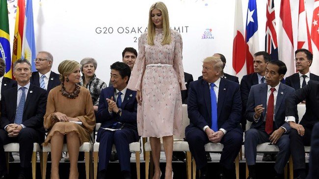 Ivanka Trump stands up to speak at the President G-20 summit event on women's empowerment in Osaka, Japan, in Osaka, Japan, Saturday, June 29, 2019. President Donald Trump, center right, also attends. (AP Photo/Susan Walsh)