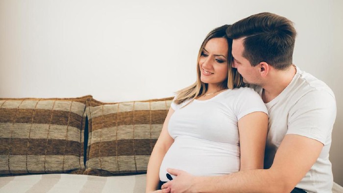 Young future parents relaxing at home