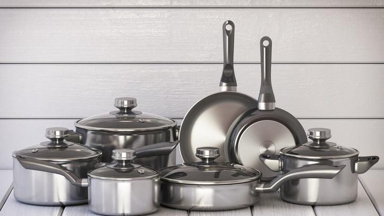 Set of stainless pots and pan with glass lids on the white wooden background. 3d illustration