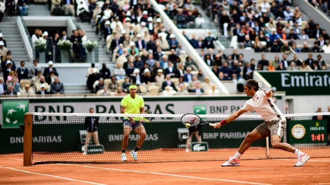 Switzerland's Roger Federer returns the ball to Spain's Rafael Nadal during their men's singles semi-final match on day 13 of The Roland Garros 2019 French Open tennis tournament in Paris on June 7, 2019. (Photo by Martin BUREAU / AFP)