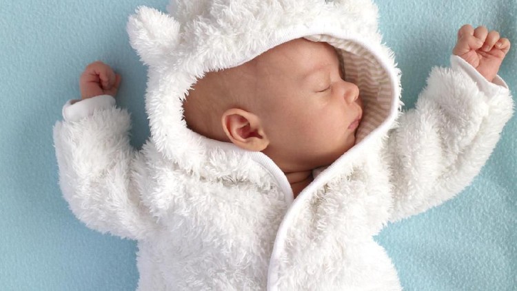 Baby in teddy bear suit