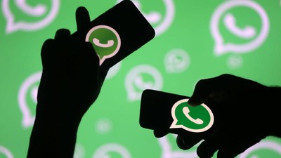 Logo Whatsapp Men pose with smartphones in front of displayed Whatsapp logo in this illustration September 14, 2017. REUTERS/Dado Ruvic