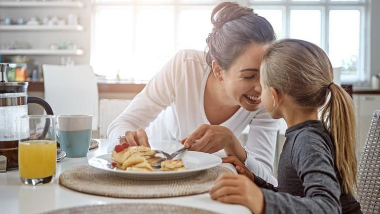Cropped shot of a mother and daughter having breakfast at home