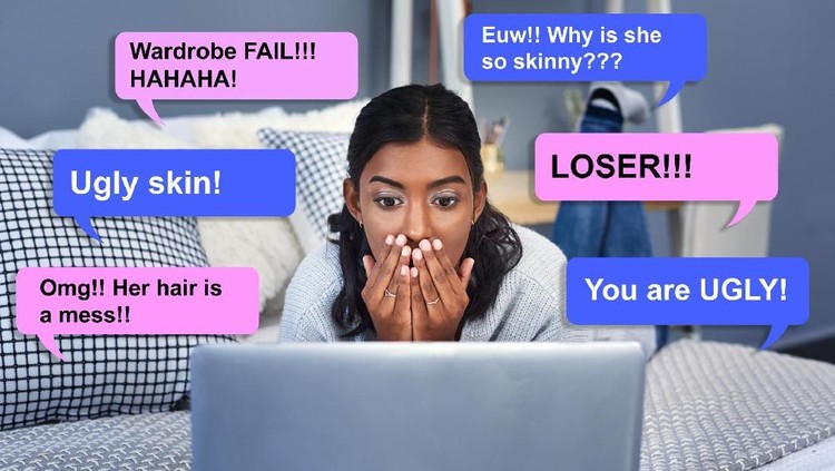 Shot of an attractive young woman being cyber bullied online while chilling on her bed in her bedroom at home