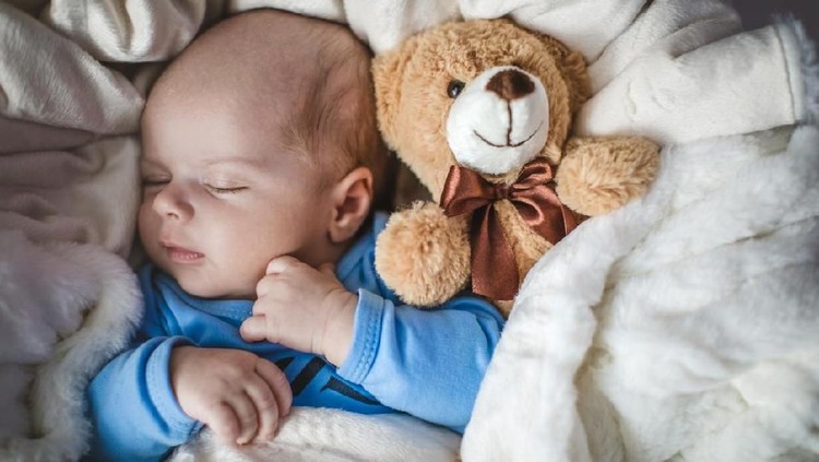 Newborn baby boy laying in crib