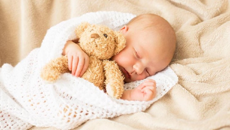 Baby girl sleeping tugged in a blanket
