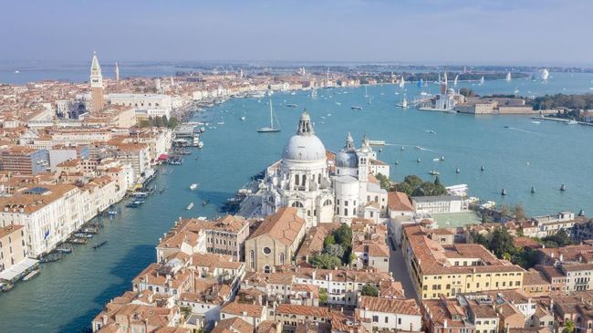 Aerial of the stunning Venice skyline with the most famous tourist attractions and the Veleziana Regatta in back. Converted from RAW.