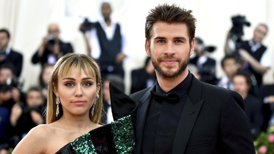 FILE - In this May 6, 2019 file photo, Miley Cyrus, left, and Liam Hemsworth attend The Metropolitan Museum of Art's Costume Institute benefit gala celebrating the opening of the 