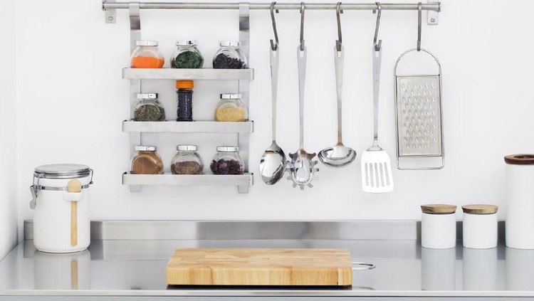 Kitchen utensils and spices in bowls in stainless steel kitchen