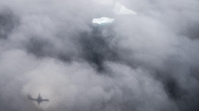 In this photo taken on Wednesday, Aug. 14, 2019, Icebergs are covered by clouds near Kulusuk, Greenland. Greenland has been melting faster in the last decade and this summer, it has seen two of the biggest melts on record since 2012. (AP Photo/Felipe Dana)
