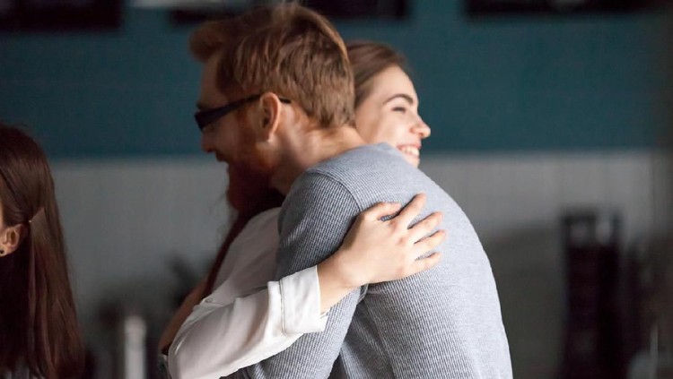Ilustrasi Pasangan Friendly hug concept, smiling millennial man and woman embracing glad to see each other greeting at meeting, young guy and girl cuddling expressing care, friendship and good warm relations concept