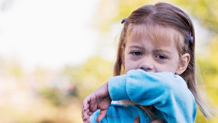 This sweet little girl shows the viewer the correct way to sneeze or cough by using the inside of her elbow and not her hands.