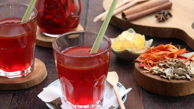 694655252 Wedang Uwuh, traditional herb drink from Jogjakarta, Indonesia. Contains a variety of leaves: cinnamon, nutmeg and cloves leaves. Another ingredient is wood from the secang tree, ginger and lump sugar