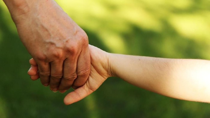Young and old hands together
