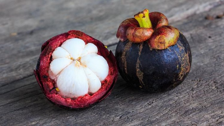 Fresh Mangosteen Fruit on Wooden Table.
