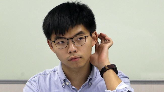 Hong Kong activist Joshua Wong listens to the press after meeting with Taiwan Democratic Progressive Party (DPP) political leaders in Taipei, Taiwan, Tuesday, Sept. 3, 2019. Joshua Wong visits pro-democracy political leaders and joint forum during a two-days trip from Tuesday in Taiwan. (AP Photo/ Chiang Ying-ying)