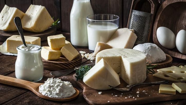 Dairy products assortment shot on rustic wooden table. Dairy products included are milk, yogurt, butter, goat cheese, mozzarella, ricotta, Parmesan cheese, emmental cheese, eggs and hard cheese. Low key DSRL studio photo taken with Canon EOS 5D Mk II and Canon EF 100mm f/2.8L Macro IS USM