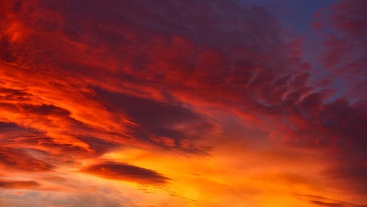 horizontal nature background of sky in fire colors, red, orange, yellow.