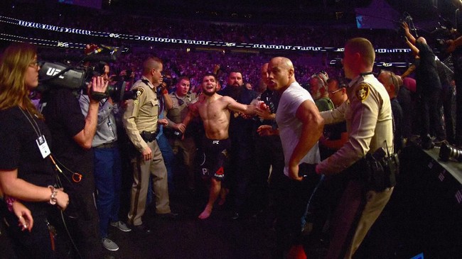 LAS VEGAS, NV - OCTOBER 06: Khabib Nurmagomedov of Russia is escorted out of the arena after defeating Conor McGregor of Ireland in their UFC lightweight championship bout by way of submission during the UFC 229 event inside T-Mobile Arena on October 6, 2018 in Las Vegas, Nevada.   Harry How/Getty Images/AFP