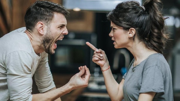 Angry millennial couple arguing shouting blaming each other of problem, frustrated husband and annoyed wife quarreling about bad marriage relationships, unhappy young family fighting at home concept