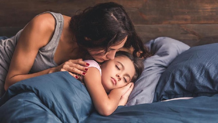 Photo of charming adorable little girl and her older sister teenager hugging each other