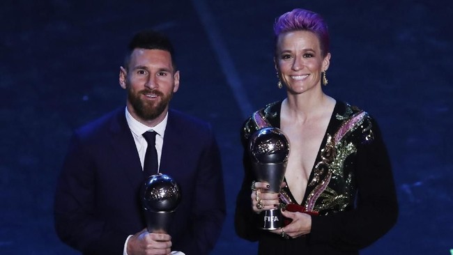 Argentinian Barcelona player Lionel Messi poses with United States forward Megan Rapinoe after they received the Best FIFA Men's, Women's player award during the Best FIFA soccer awards ceremony, in Milan's La Scala theater, northern Italy, Monday, Sept. 23, 2019. (AP Photo/Antonio Calanni)