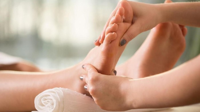Close-up of female hands doing foot massage