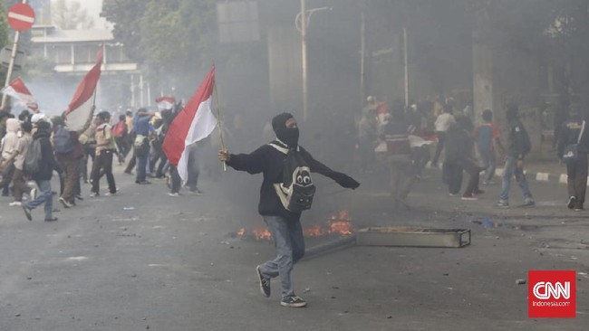 Pantauan CNNIndonesia.com, massa unjuk rasa yang turut melibatkan pelajar mendobrak pintu gerbang Gedung DPR sambil melempari batu ke arah aparat berkali-kali.