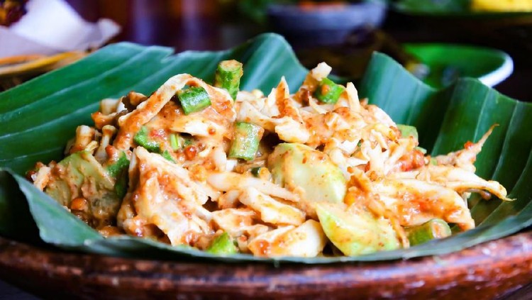 Karedok, typical indonesian traditional food made from fresh raw vegetables mixed with brown sugar chilli and peanut sauce