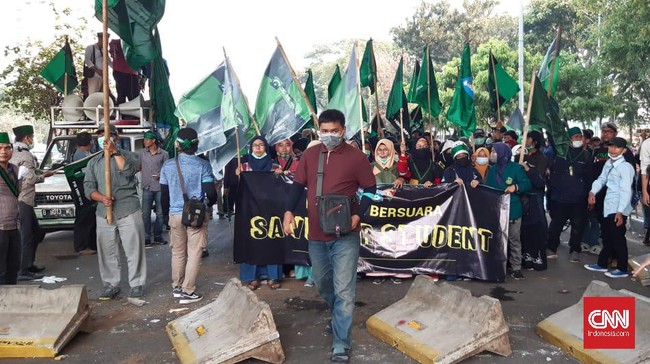 Puluhan massa merobohkan pembatas yang dibentuk polisi untuk menghalau aksi mahasiswa yang akan menuju gedung DPR RI.