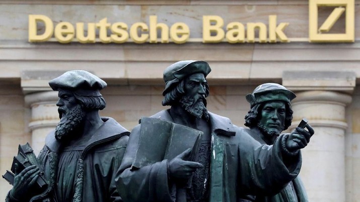 FILE PHOTO: A statue is pictured next to the logo of Germany's Deutsche Bank in Frankfurt, Germany, September 30, 2016. REUTERS/Kai Pfaffenbach/File Photo