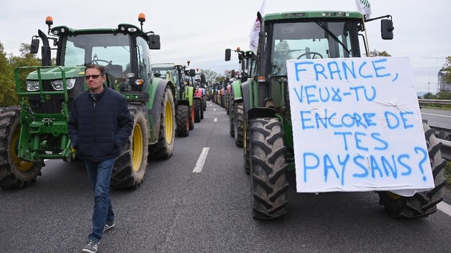 Nyaris 1.000 petani Prancis memblokade jalan menuju Paris, menuntut upah bayaran dan aturan impor barang yang memberatkan petani lokal.