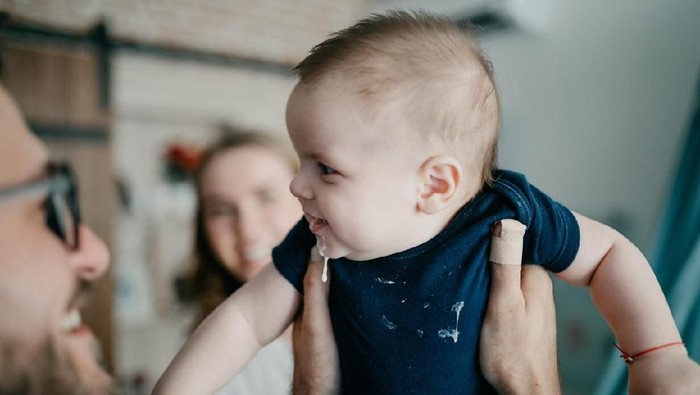 Baby Spit Up Curdled Milk and smiling