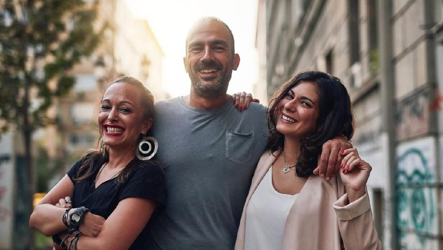 Shot of three friends having fun while out in the city